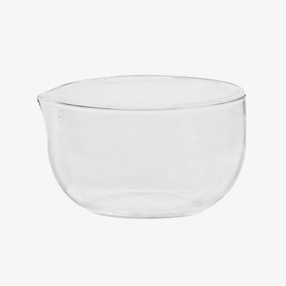 Clear glass matcha bowl with rounded sides and a pouring spout, designed for whisking matcha while watching the foam form.
