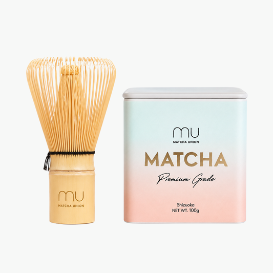 Matcha Union Premium Matcha Kit with a 100g tin of Shizuoka matcha and a logo-engraved bamboo whisk, for preparing smooth daily lattes.
