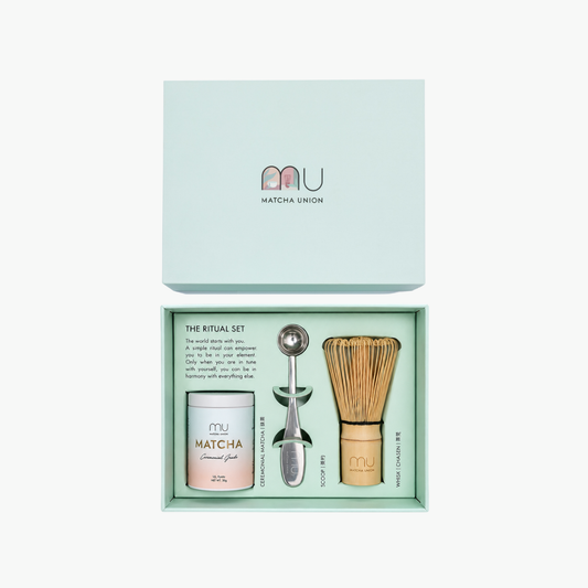 Open Matcha Union Ritual Set gift box containing a 30g ceremonial matcha tin, bamboo whisk and stainless steel scoop, with the mint-green lid above.