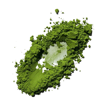 Green Premium Matcha powder spread on a white background, showing its fine texture, small clumps and a curved indentation through the centre.